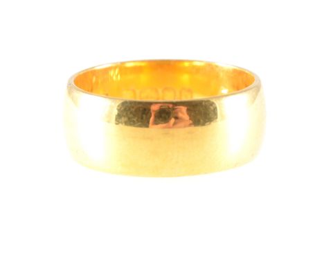 A 22 carat yellow gold wedding band, plain polished 7.7mm wide D shape, approximate weight 9.4gms, ring size O.