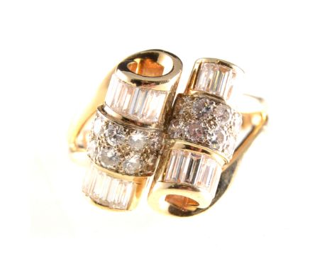 A diamond cocktail ring, two scrolls to the front, each scroll set with twelve baguette cut diamonds and eight brilliant cut 