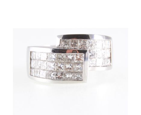 A modern diamond crossover ring, thirty-six princess cut stones, pave set in an all white metal crossover mount, 5.5mm wide s