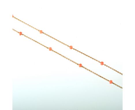 A yellow metal guard chain, the trace link guard chain spaced by thirty-six 4mm coral beads, overall length 140cm with a bolt
