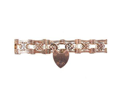 A rose metal bracelet, 14mm wide gate design with eleven quatrefoil mofits, padlock fastener stamped 9ct, length 18cm, approx