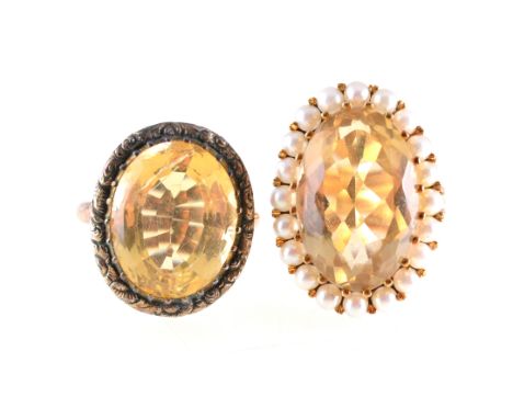 Two citrine dress rings, one having an oval mixed cut citrine 20mm x 12mm, and surrounded by twenty 2.5mm cultured pearls in 