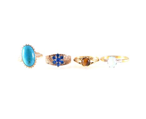 Four gemset dress rings, an oval cabochon cut turquoise matrix 15mm x 8mm collet set in a 9 carat yellow gold closed back mou