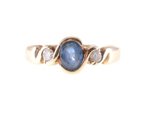 A sapphire and diamond three stone ring, an oval mixed cut sapphire with a brilliant cut diamond to each side set in a 9 cara