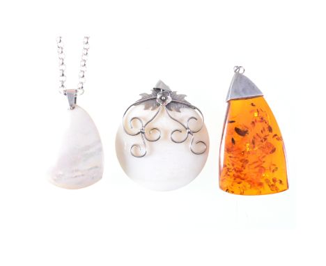 A collection of modern silver and white metal jewellery, pendants and necklaces set with mother-of-pearl, baltic amber, silve