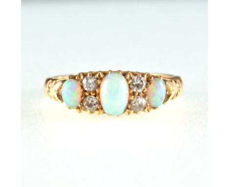An opal and diamond half hoop ring, three oval cabochon cut opals, graduating in size and spaced by two pairs of old cut diam