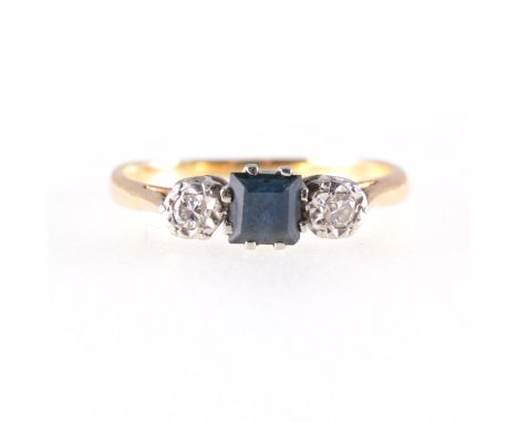 A sapphire and diamond three stone ring, a square step cut sapphire claw set with Swiss cut diamond illusion set to each side