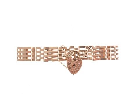 A 9 carat yellow gold bracelet, four bar gate link design, 12mm wide fitted with a padlock fastener and safety chain, approxi