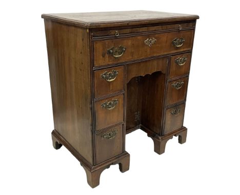 George II figured walnut and mahogany kneehole desk, the rectangular book-matched veneer top with crossbanding and moulded ed