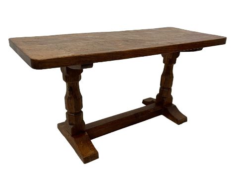 Mouseman - oak coffee table, rectangular adzed top, octagonal pillars on sledge feet united by floor stretcher, carved with m