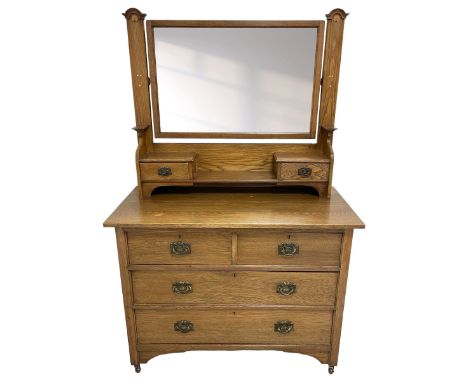 Arts & Crafts oak dressing table, raised rectangular bevelled mirror back over two small trinket drawers and shelf, the raise