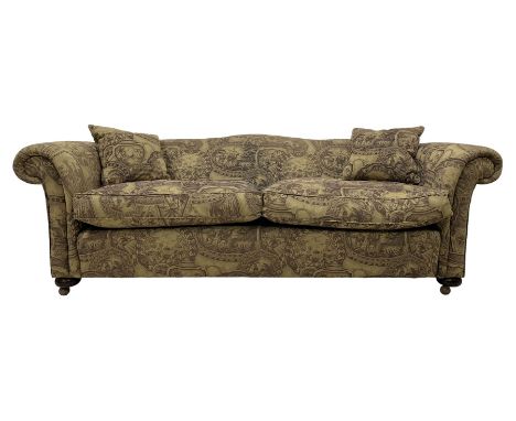 Grande three-seat sofa, traditional camelback shape with rolled arms and feather stuffed cushions, upholstered in patterned f
