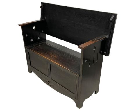 Arts & Crafts period oak monk's bench, hinged and sliding back over hinged box seat, on solid end supports pierced with styli