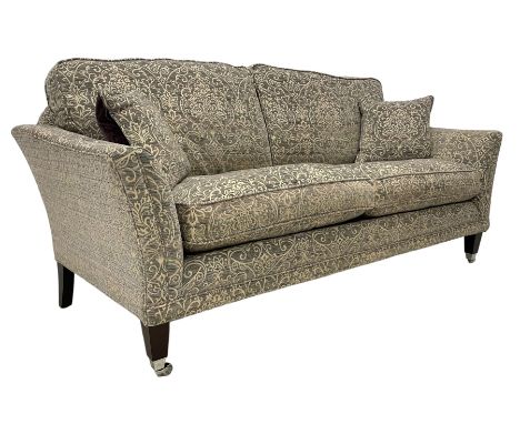 Parker Knoll - grande hardwood-framed two-seat sofa, upholstered in pale heather fabric with scrolling foliate pattern, on ma