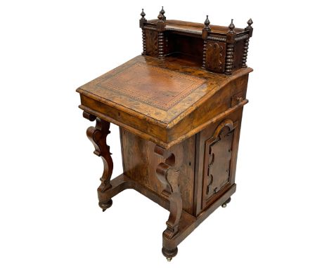 Victorian figured yew wood davenport, raised back with turned finials and bead moulded edge with two cupboards applied with s