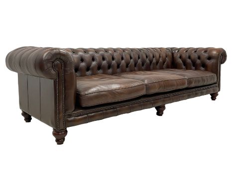 Distinctive Chesterfields - large three-seat Chesterfield sofa, upholstered in buttoned brown leather with studded bands, on 