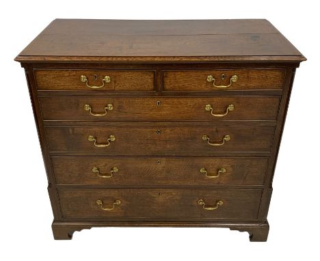 George III oak chest, moulded rectangular top over two short and four long graduating cock-beaded drawers, canted upright cor