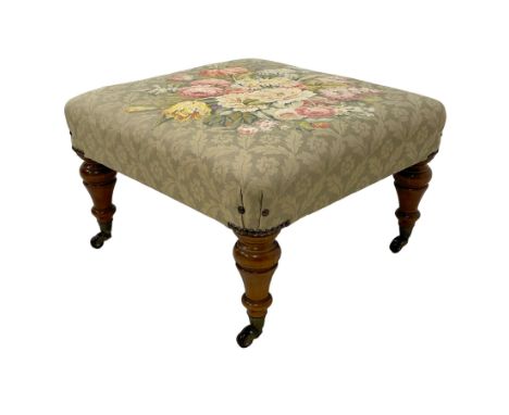 Victorian design walnut framed footstool, floral upholstered seat, on turned feet with brass and ceramic castorsDimensions: H