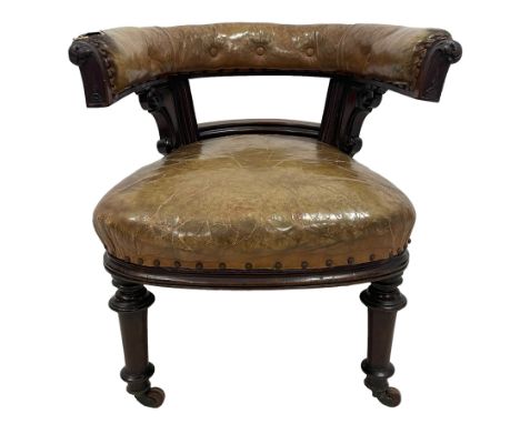 Early Victorian mahogany framed tub library reading chair, the curved cresting rail with foliate terminals, upholstered in bu
