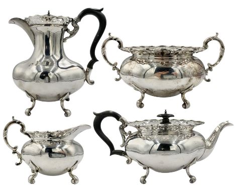 Early 20th century silver four piece tea set of oval design with pierced borders and scroll feet, the tea pot and hot water j