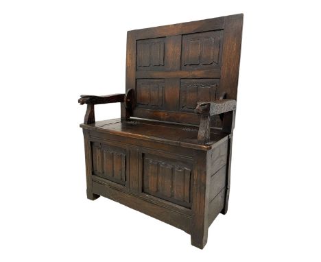 20th century oak box-seat monk's bench, hinged top with four linenfold carved panels, projecting tooled arms with mask carved