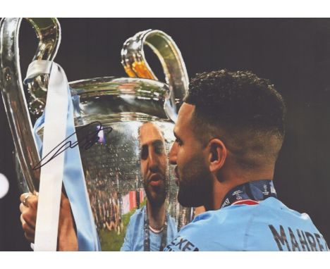 Riyad Mahrez signed 12x8inch colour photo pictured with the Champions League trophy during his time with Manchester City. Goo
