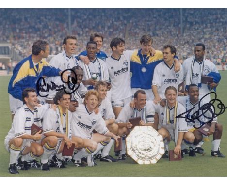 Autographed LEEDS UNITED 8 x 6 photo : Col, depicting Leeds United players celebrating with the Charity Shield in front of ph