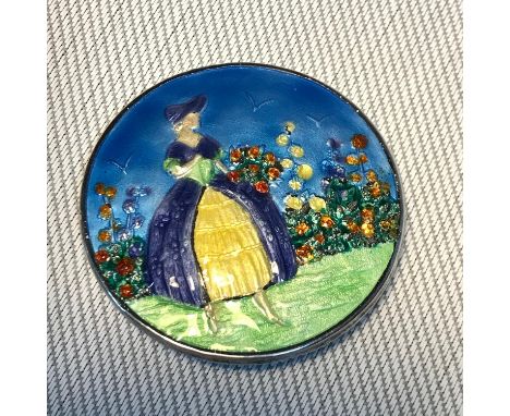 A Birmingham silver and enamel lady with flowers brooch, Makers F.J.M &amp; Co dated 1947. Measures 4.6cm in diameter 