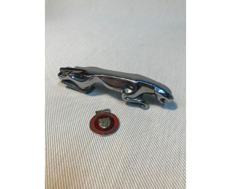 A Vintage Jaguar mascot together with a Jaguar enamelled badge. 