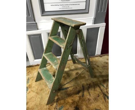 A Vintage set of A Frame step ladders, fitted with metal hinges and still showing signs of original green paint. 