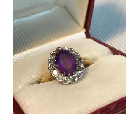 A Beautiful example of a ladies 18ct gold diamond cluster and large Amethyst stone ring. Ring size L1/2, Weighs 3.59grams 