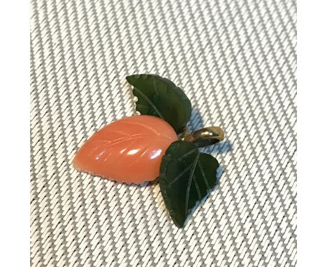 A 9ct gold pendant designed with jade and coral leafs, Weighs 2.38grams 