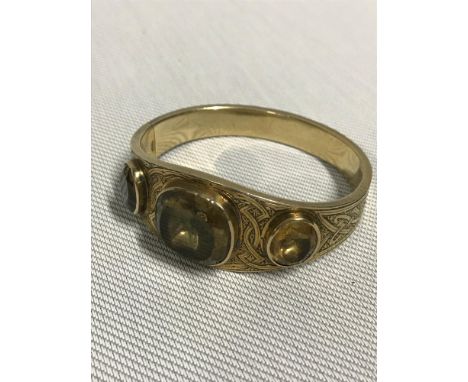 A Tested 18ct gold Victorian or earlier ladies bangle, designed with Celtic detailing and three large citrine style stones. T