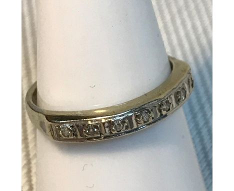 A 9ct gold band ring set with 7 diamonds, Ring size M, Weighs 2.05grams 