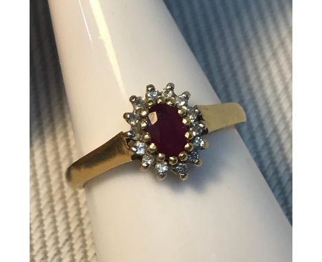 A Birmingham 18ct gold ladies diamond cluster and single ruby stone ring, Ring size N, Weighs 3,46grams 