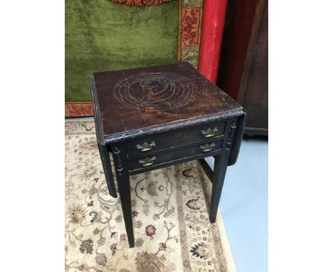 A Georgian side table designed with two under drawers and drop end sides. The top of the table is designed with a hand carved