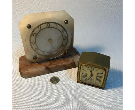 A Marble Art Deco mantle clock in a working condition together with an Antique Brevete alarm clock in a working condition. 