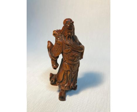 A Chinese boxwood hand carved warrior GuanGong netsuke. Measures 12cm in height 