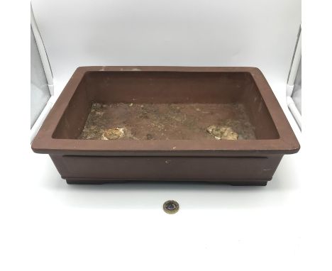 A Late 20th century bonsai tree clay rectangular planter with Zhong Guo Yixing impressed mark to the base. Measures 9.5x36x25