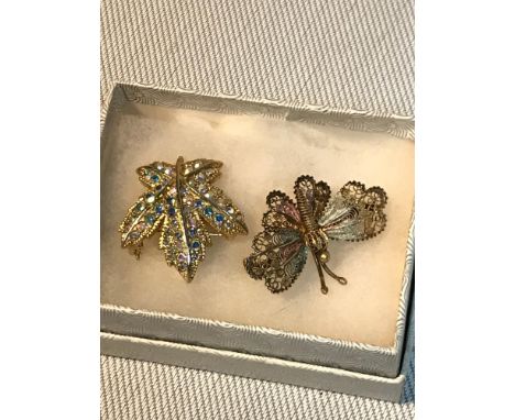 An 800 grade silver butterfly brooch detailed with enamel colours together with a costume brooch. 