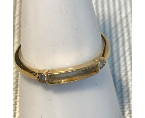 An 18ct gold ladies ring set with two single round diamonds, missing stone to centre. Ring size N. Weighs 1.40grams 