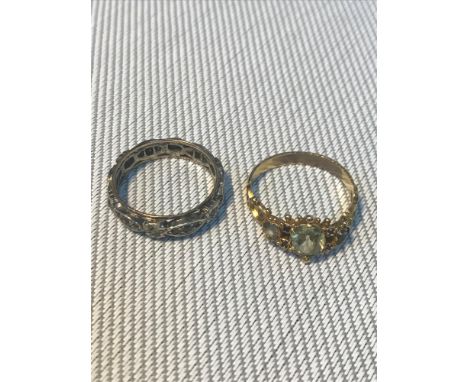 A Yellow metal ring together with a 9ct gold &amp; silver band ring. Total weight 4.25grams. 