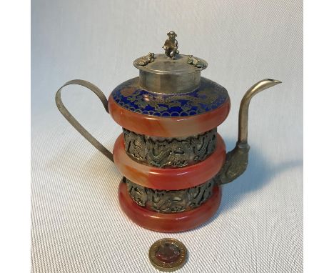 A Chinese hand worked Tibetan white metal tea pot, designed with three agate/ jade bangles, Cloisonne top and small Monkey an