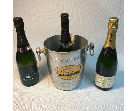 A Vintage Champagne Mercier ice bucket together with three bottles of Champagne 