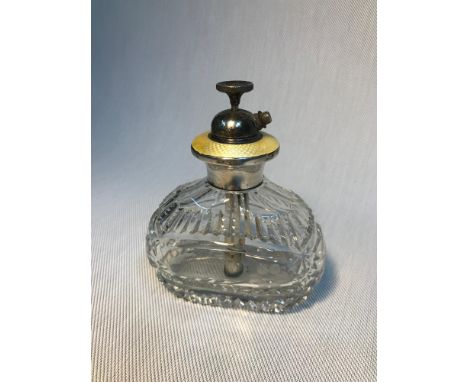 A Vintage Sterling silver and yellow enamel topped cut glass perfume bottle/ atomiser. Measures 12cm in height 