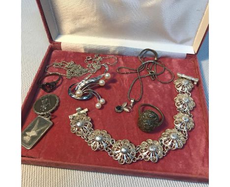A Selection of silver jewellery which includes Egyptian silver floral design bracelet, silver and pearl brooch, silver &amp; 