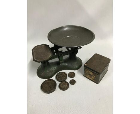 A Vintage set of kitchen scales with weight, still showing signs of original green paint. 