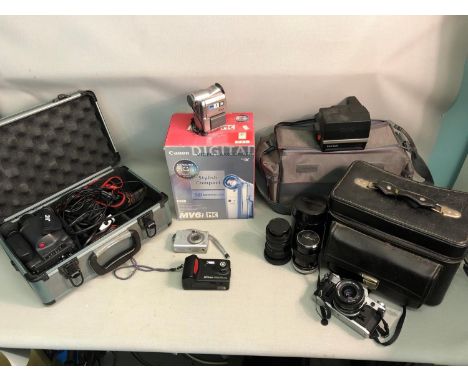 A lot of various camera and recording equipment to include Canon video camcorder, JVC camcorder in protective case, Canon cam