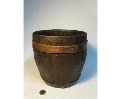 Antique wooden barrel planter fitted with copper bands. Measures 21cm in height 