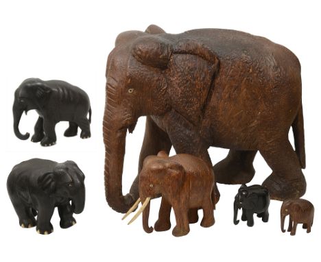 A large 19th century palm wood model of an elephant, together with five smaller models of elephants, 19th century and later, 